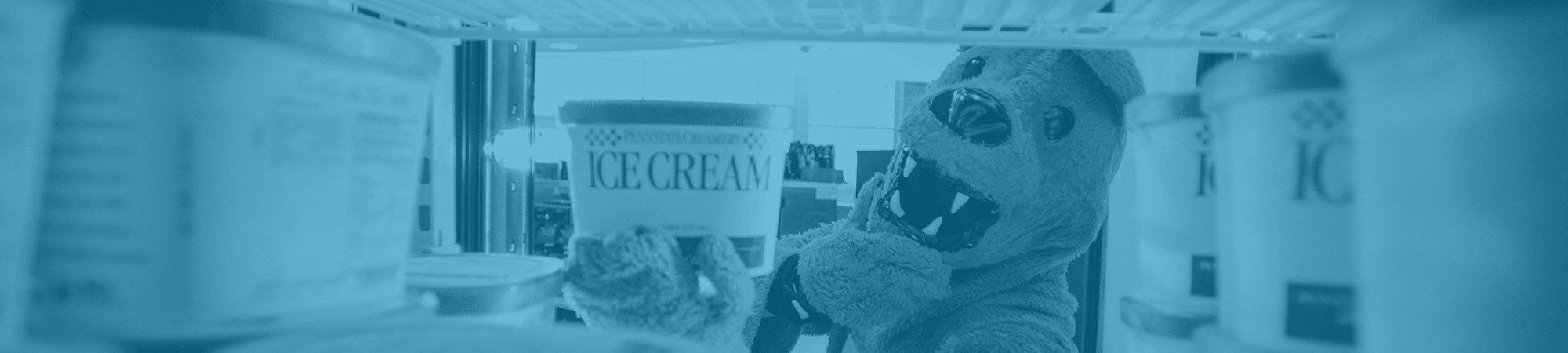 Nittany Lion selecting ice cream from cooler