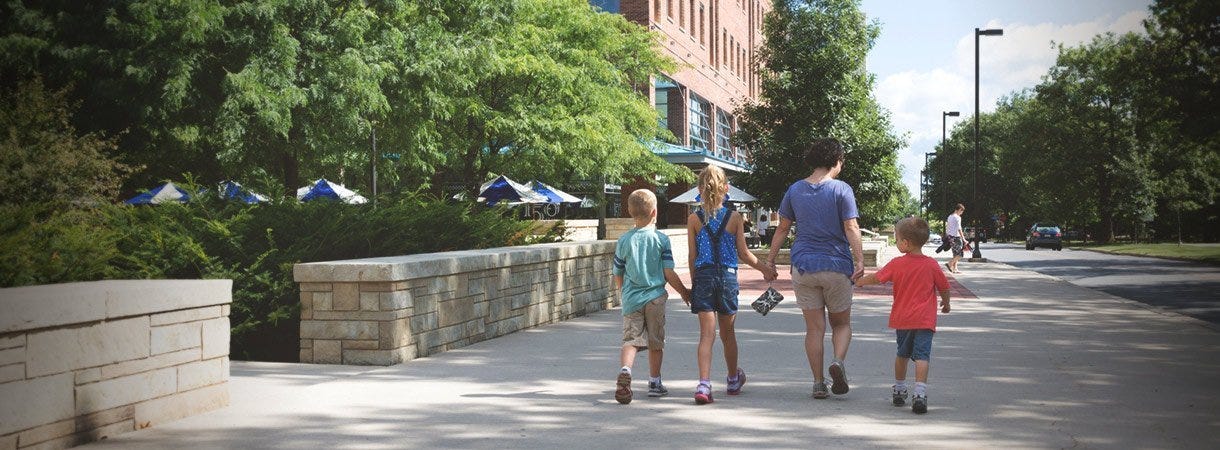 Family walking toward Berkey Creamery